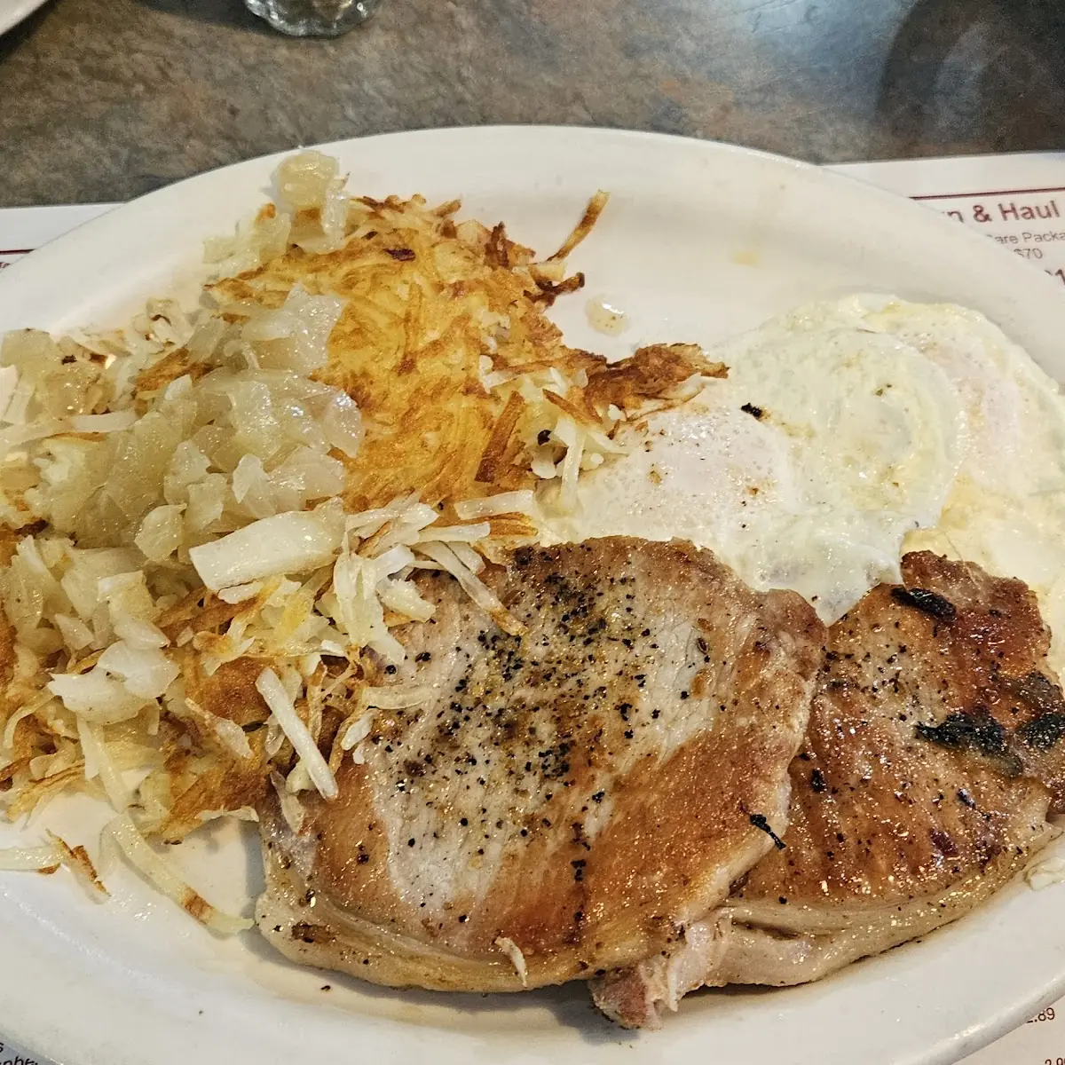 Eggs over Easy with Pork Chops and Hash Browns with Grilled Onions