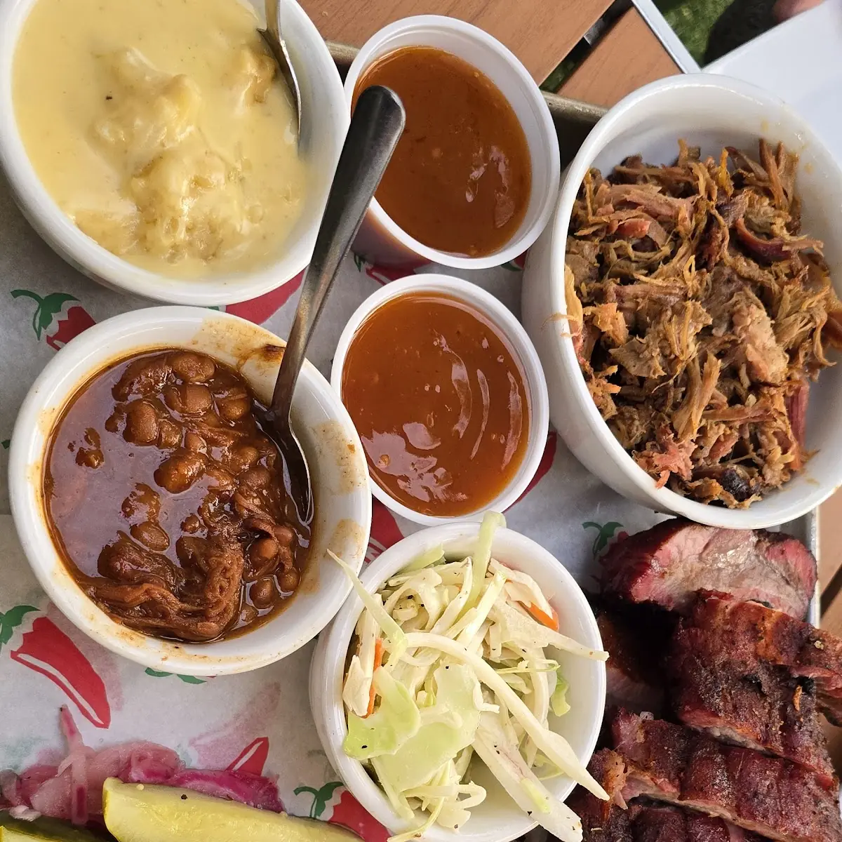 Half Chicken Half Pound Brisket Half Pound Pulled Pork Sides of Cole Slaw Beans and Cheesy Taters