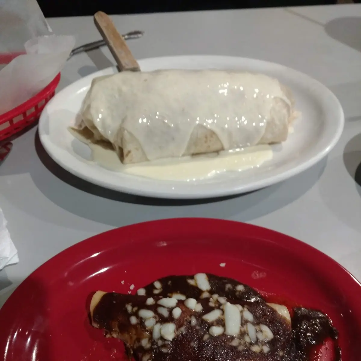 Front Chicken Enchilada with Red Sauce and Back Is Steak Burrito with White Sauce