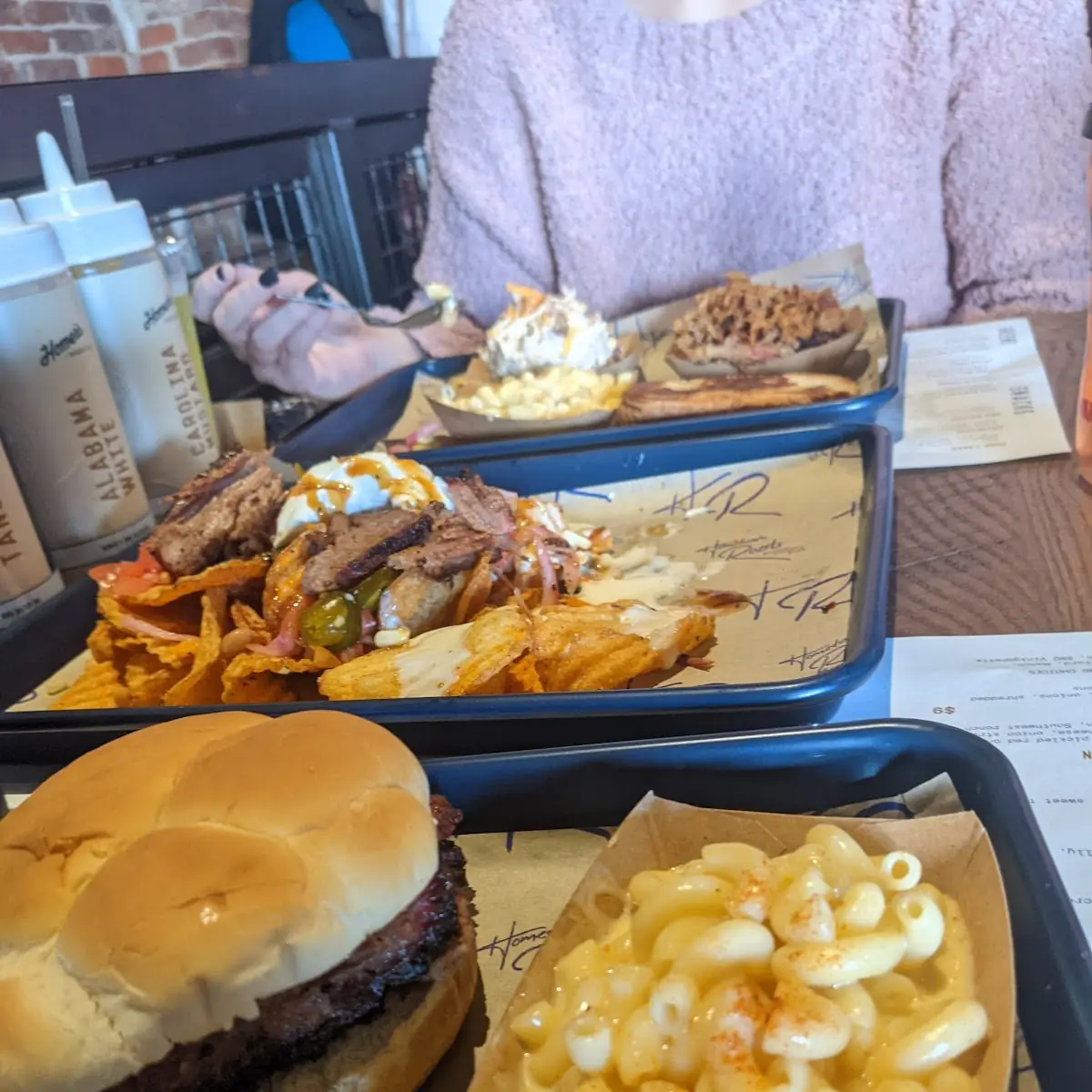 BBQ Nacho App with Brisket Brisket Sandwich Mac and Cheese and Pork on the Far Plate