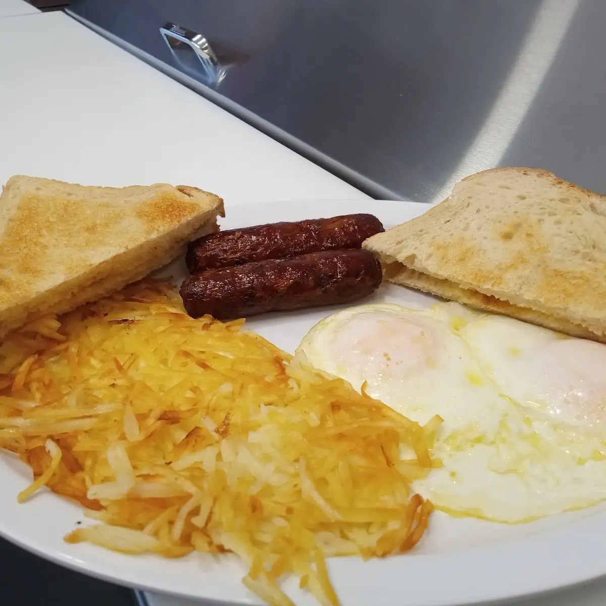 95 Two Eggs Any Style with Bacon Ham or Sausage with Hash Browns and Toast