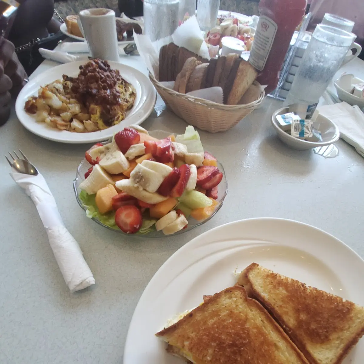 Grilled Cheese with Bacon Egg and Cheddar Cheese with Fruit Bowl Also with Chilly and Eggs Benedict