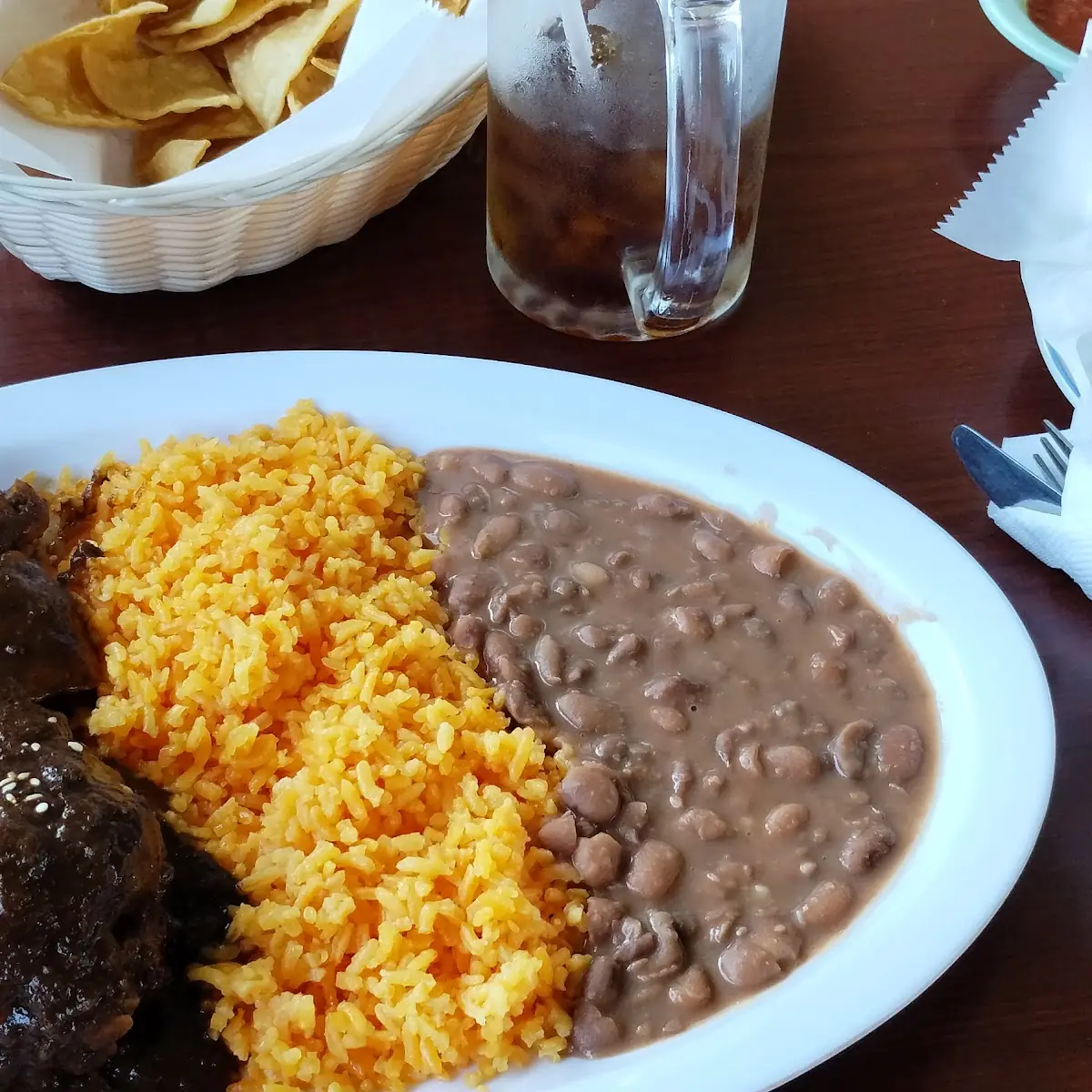 Poblano Molé Smothering 2 Chicken Legs Rice Beans