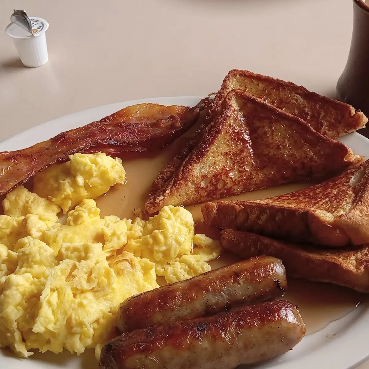 Scrambled Eggs Sausage Bacon and Toast with Coffee