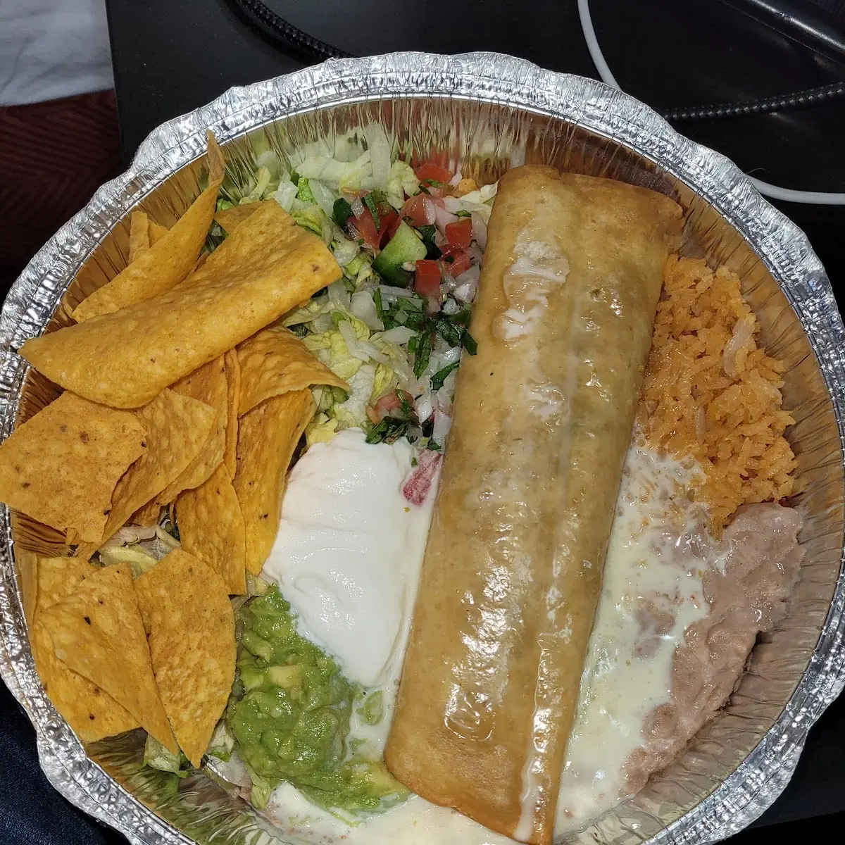 Chimichanga with Cheese Sauce Rice and Beans