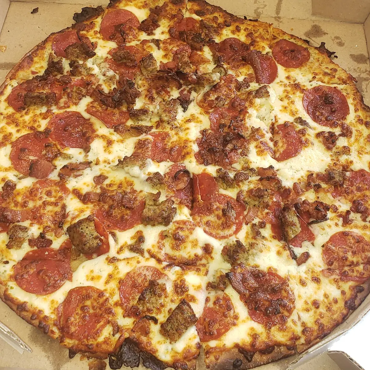Thin Crust Italian Sausage Pepperoni Bacon Pizza