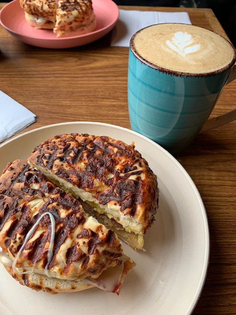 Asiago Bagel Provolone Cheese Egg and Bacon Panini Pressed with a Tailfeather Latte