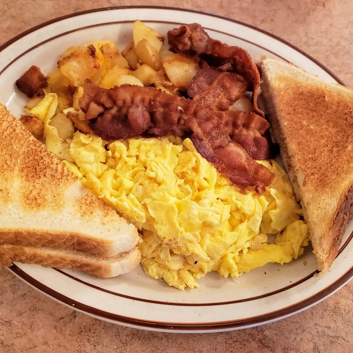 Two Eggs Scrambled Eggs Bacon Home Fries with Cinnamon Raisin Toast