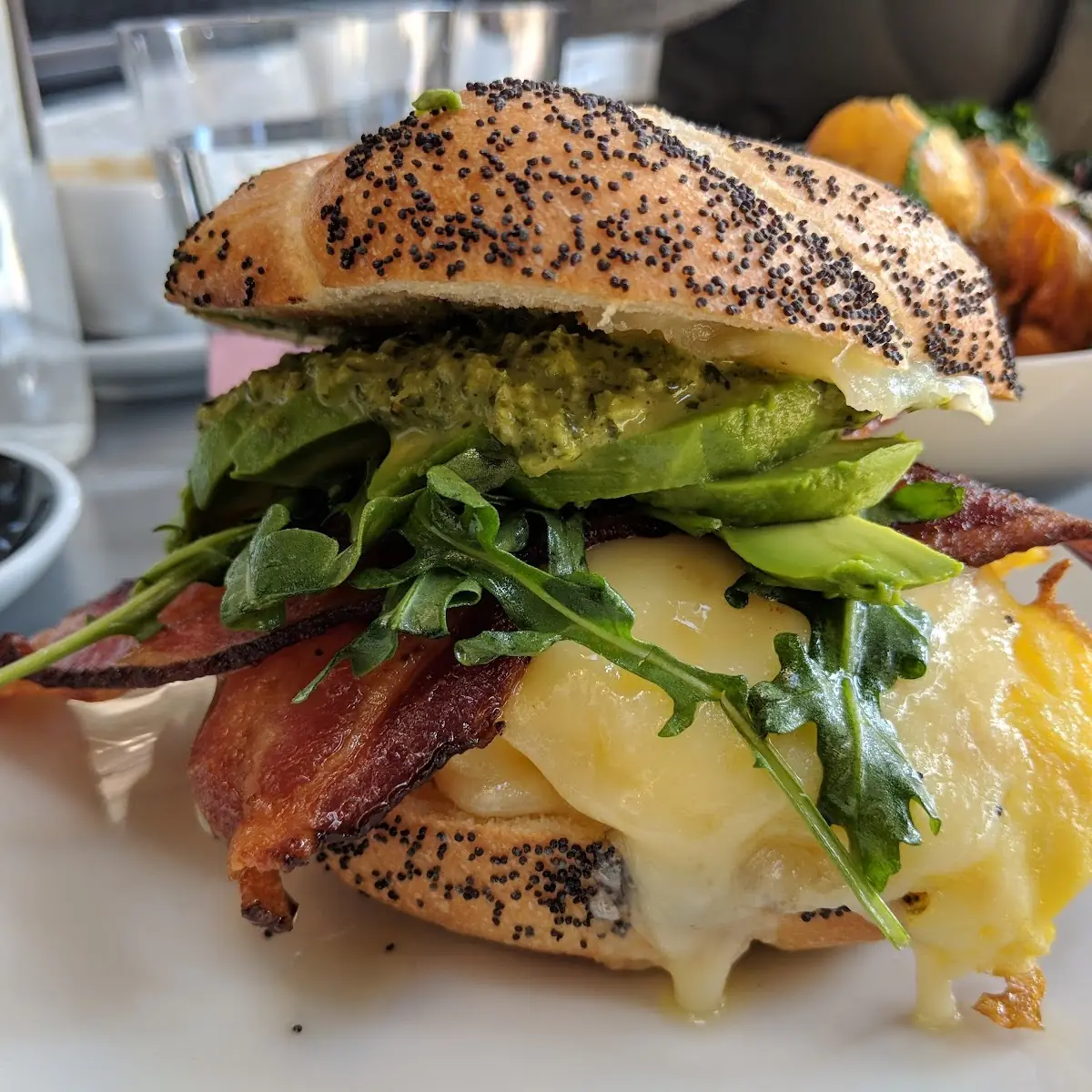 Breakfast Sandwich - Scrambled Eggs Cheddar Cheese and Bacon on Poppy Seed Kaiser Roll