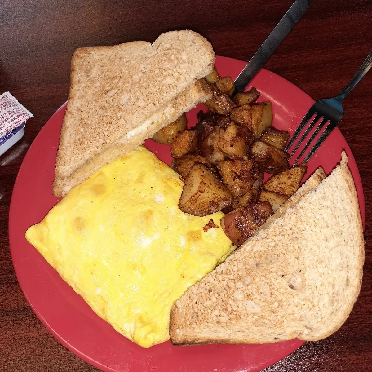 Omelette with Cheddar Cheese Fried Potatoes and Wheat Toast