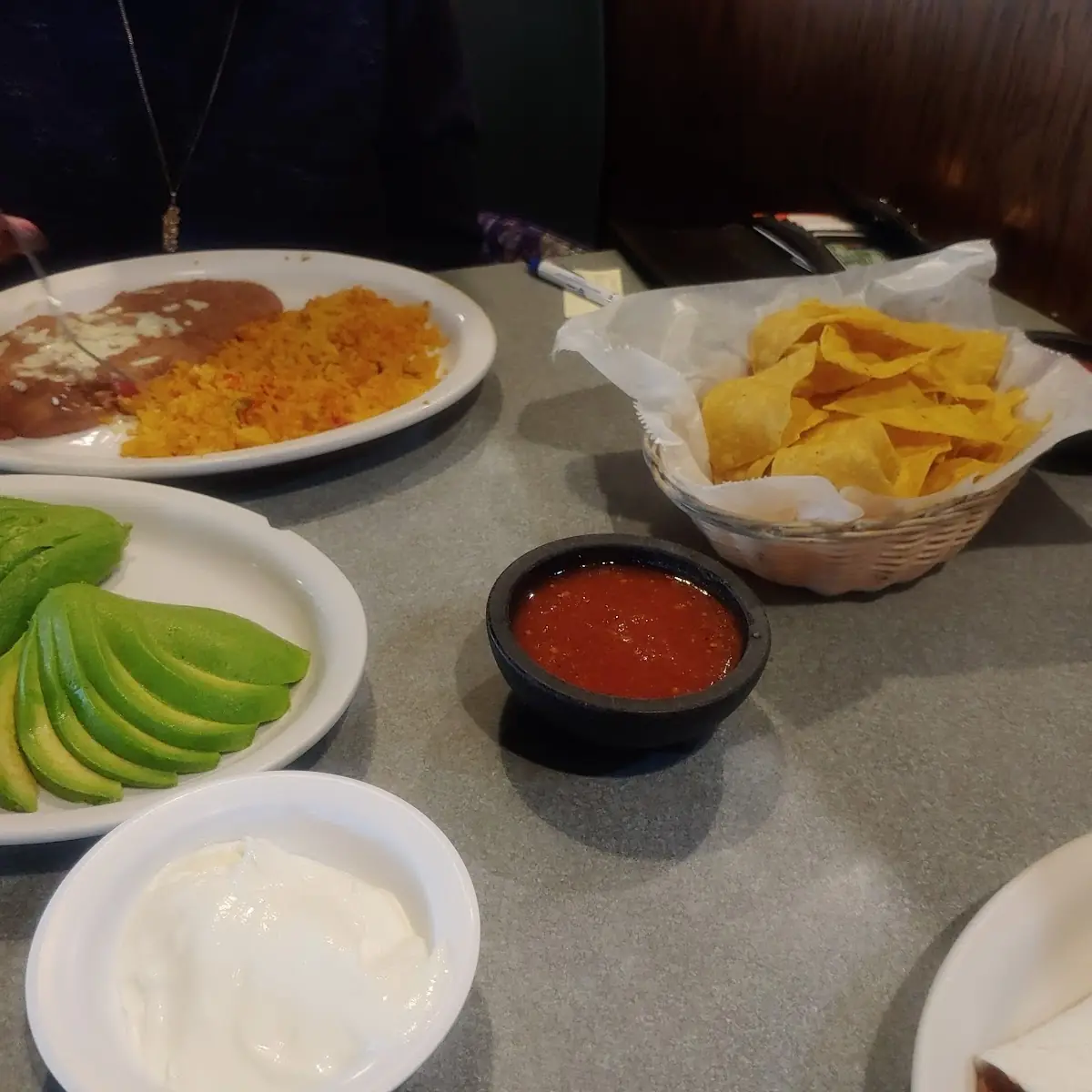 Sliced Avocado Refried Beans and Spanish Rice