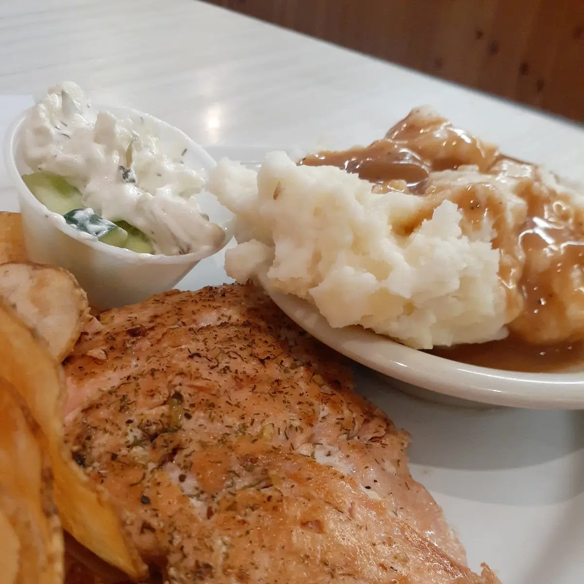 Grilled Salmon with Mashed Potatoes and Gravy Along with Homemade Potato Chips