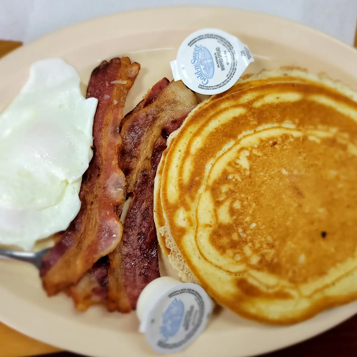 Big Pancake Bacon and 2 Eggs over Medium Egg White Cooked Throughout