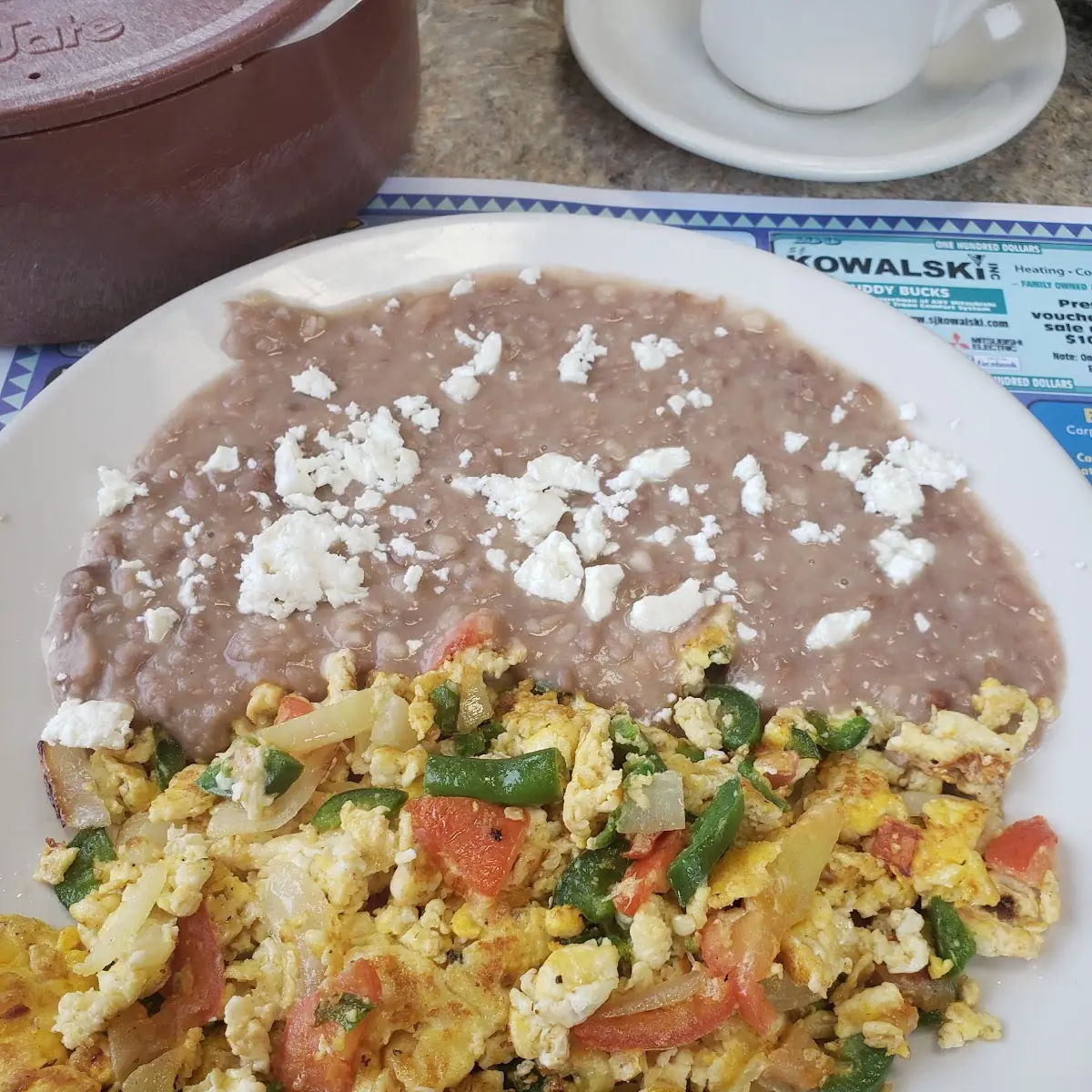 Scrambled Eggs with Tomatoes Jalapeños & Onions with a Side of Refried Beans with Feta Cheese