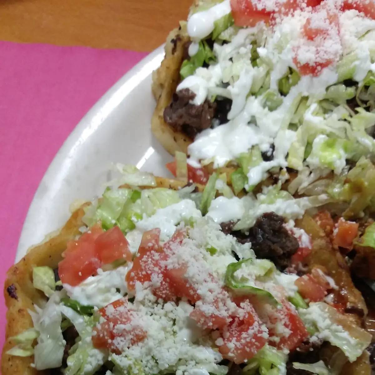 Sope with Meat with Refried Beans Lettuce Tomatoes Cheese and Sour Cream