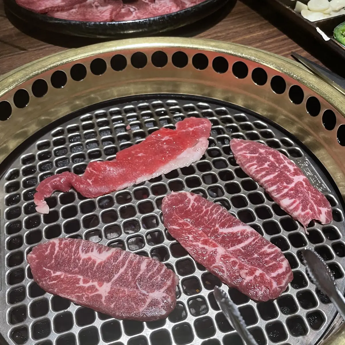 Thinly Sliced Raw Beef on Grill