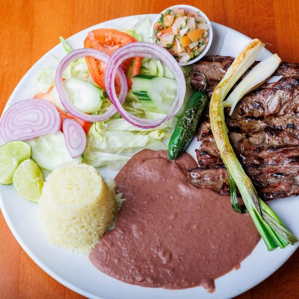 Carne Asada Con Camarones a La Plancha Grilled Steak and Shrimp with Rice Beans and Salad