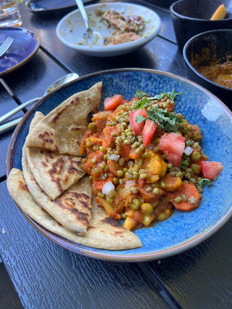 Sautéed Vegetables on Lentil Curry with Pakoras and Tamarind Served with Basmati Cumin Rice