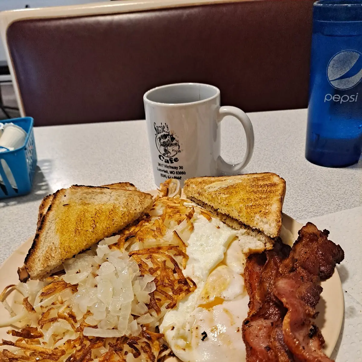 Four Eggs over Medium Hash Browns Bacon and Toast