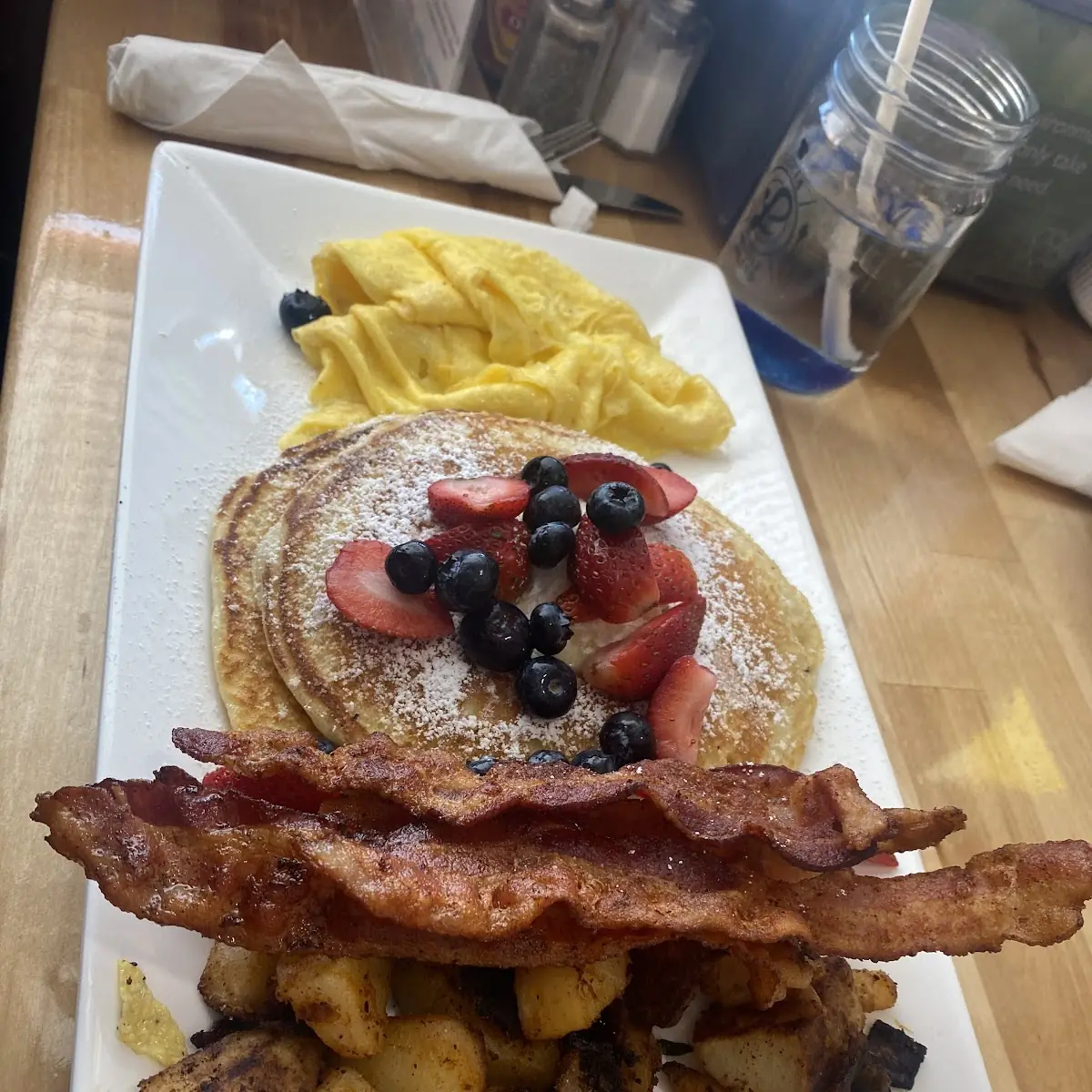 Chocolate Chip Pancakes with Fruit Medley Bacon Scramble Eggs and Potato