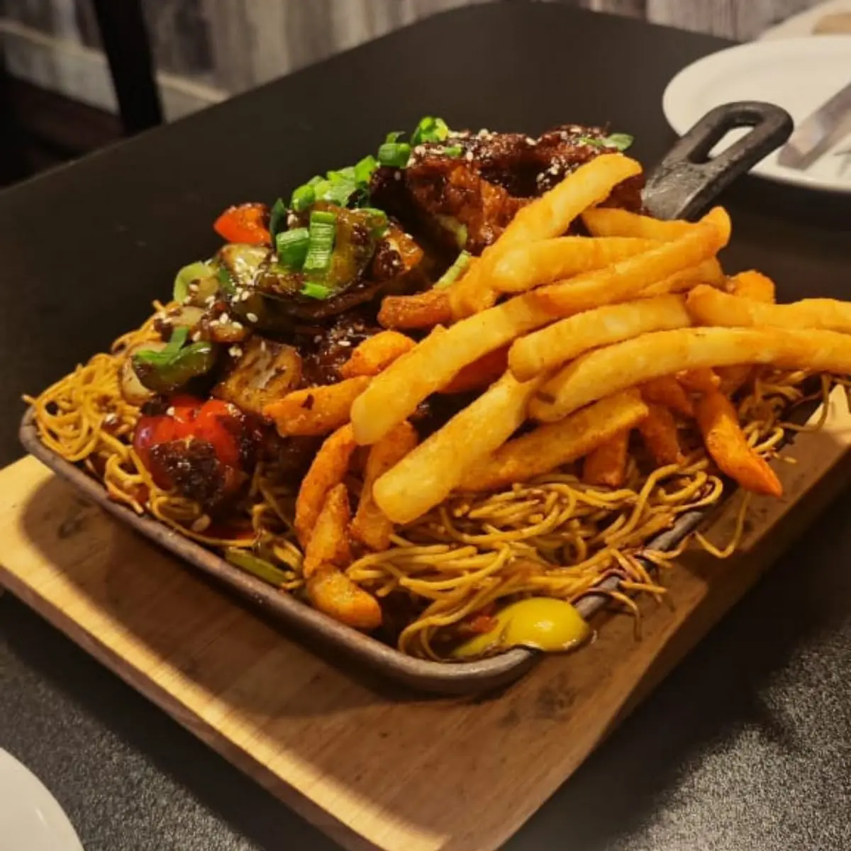 Crispy Chilly Chicken with Noodles Sizzler, Bollywood Cafe Indian Street Eats & Bar.
