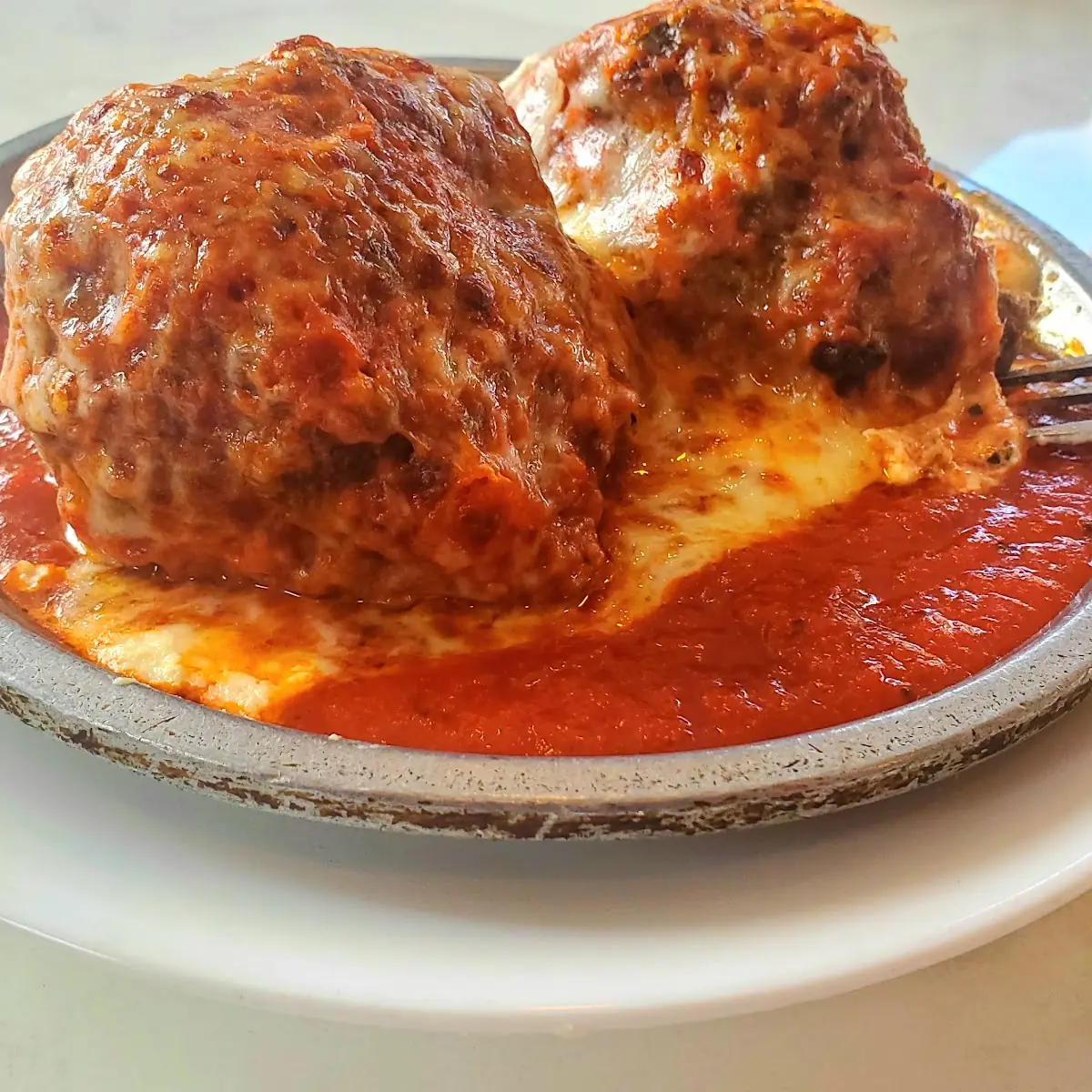 Stuffed Meatball over Some Ricotta Cheese Covered with Mozzarella Cheese