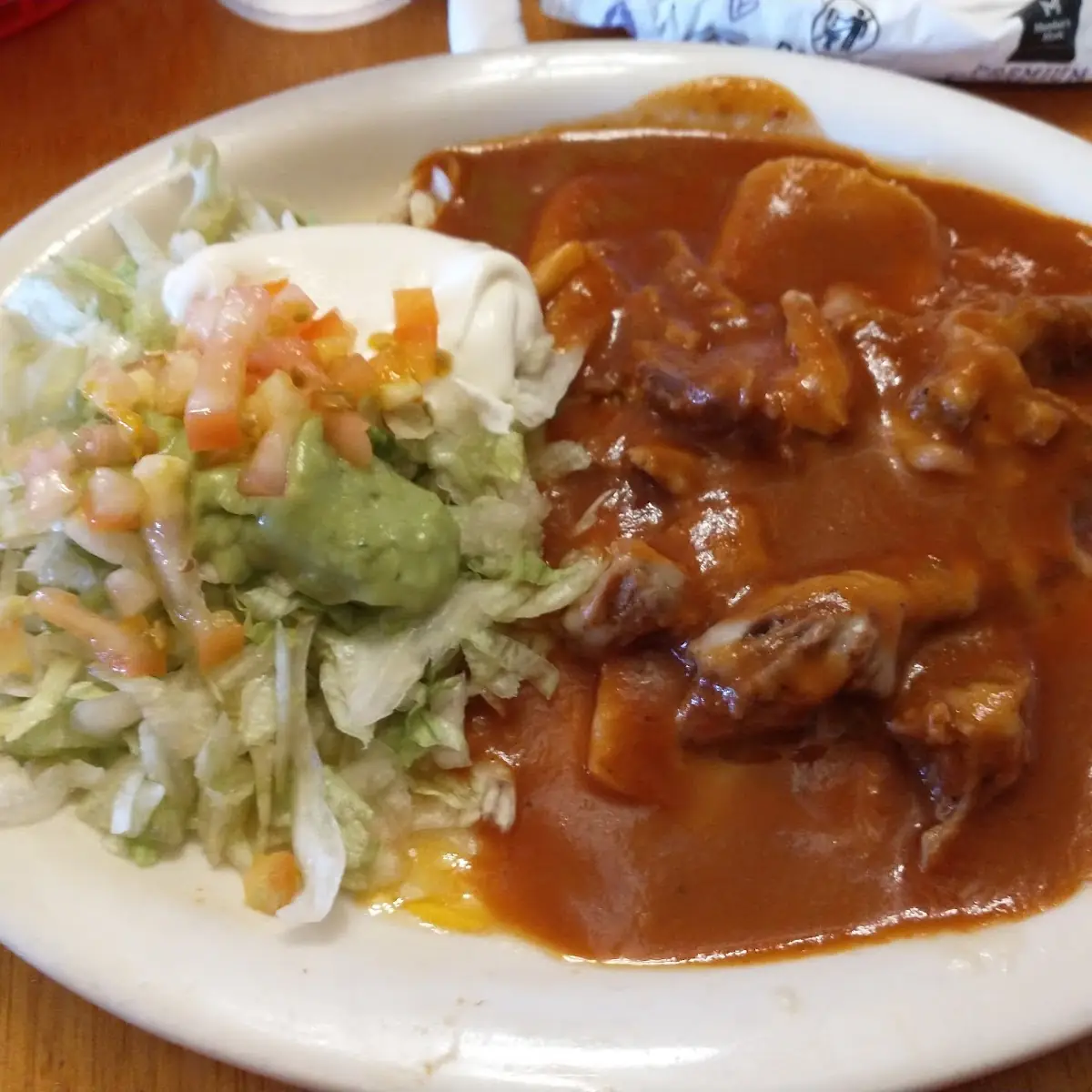 One Tostaguac One Enchilada and Refried Beans