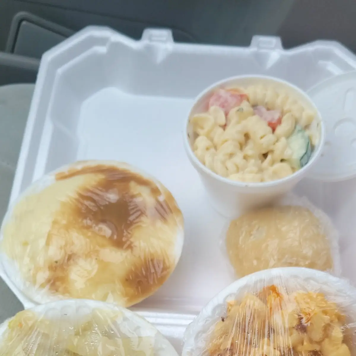 Pork Chops Cabbage Mac N chz Pasta Salad Mashed Potatoes and Gravy with a Roll