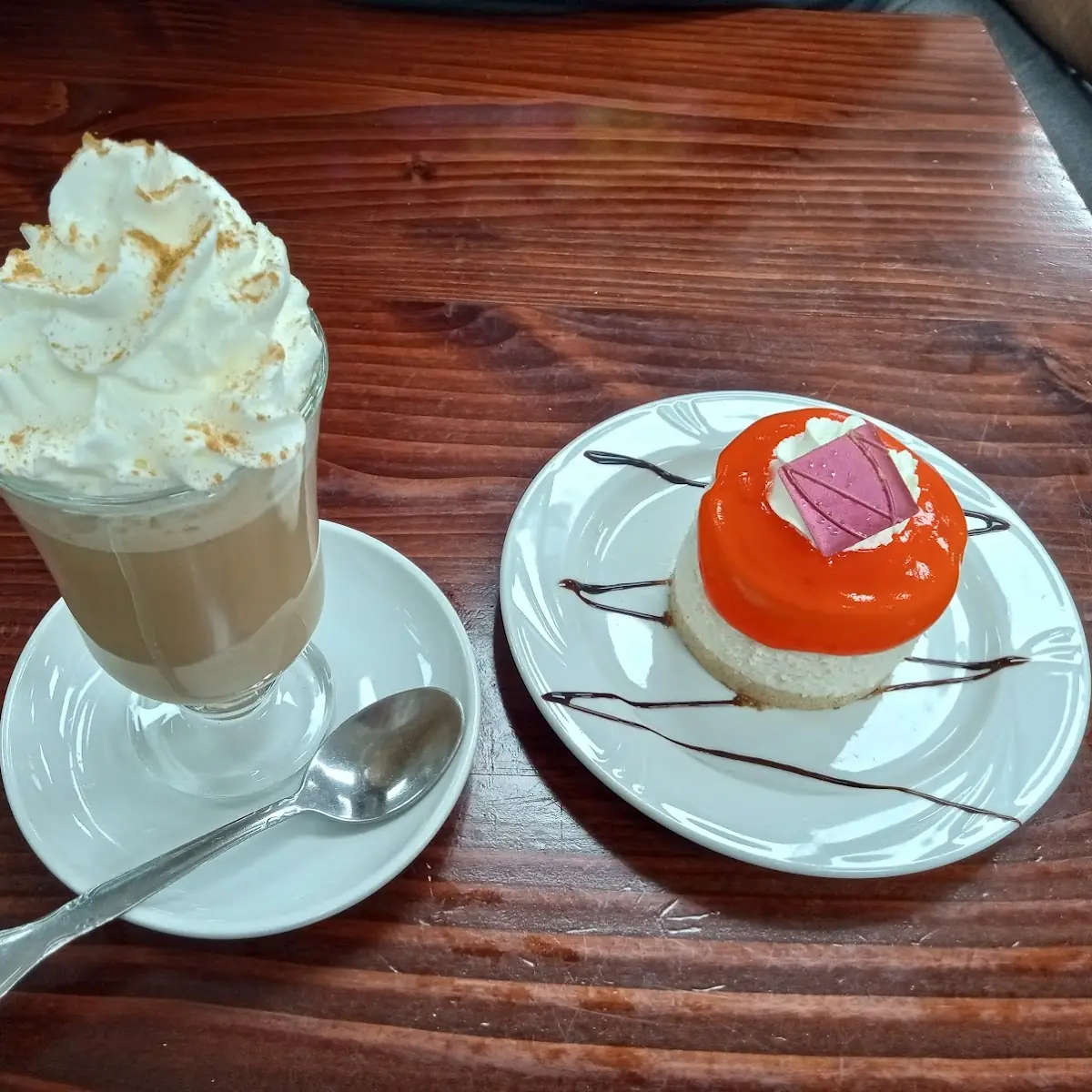 Cappuccino and Freshly Made Strawberry Cheesecake with Chocolate Garnish