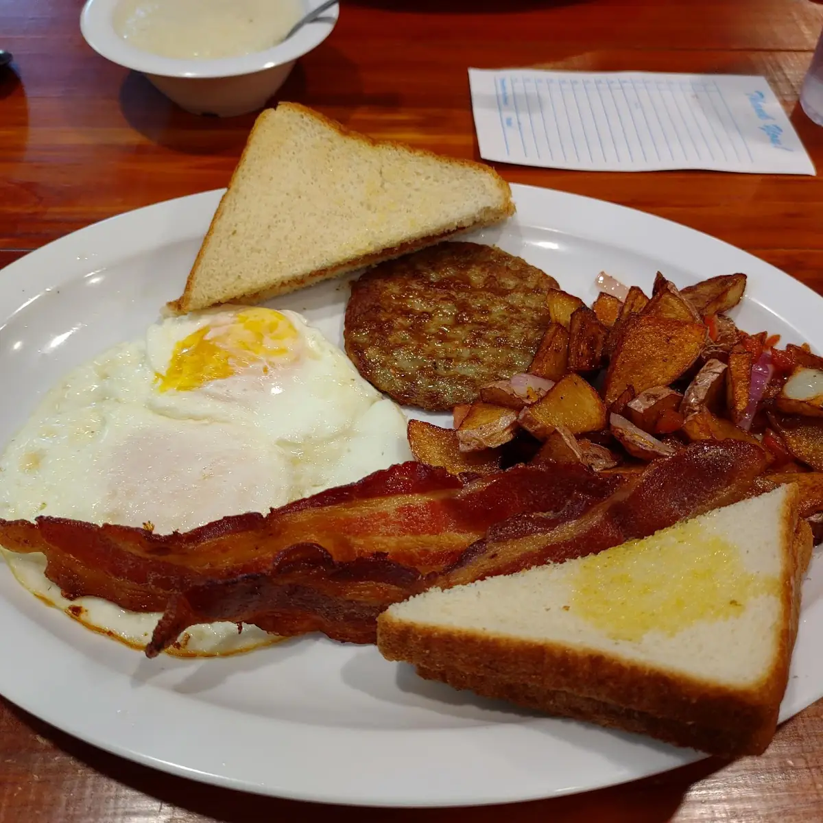 Cowboy Breakfast Special with Bacon Sausage Eggs over Medium and Toast