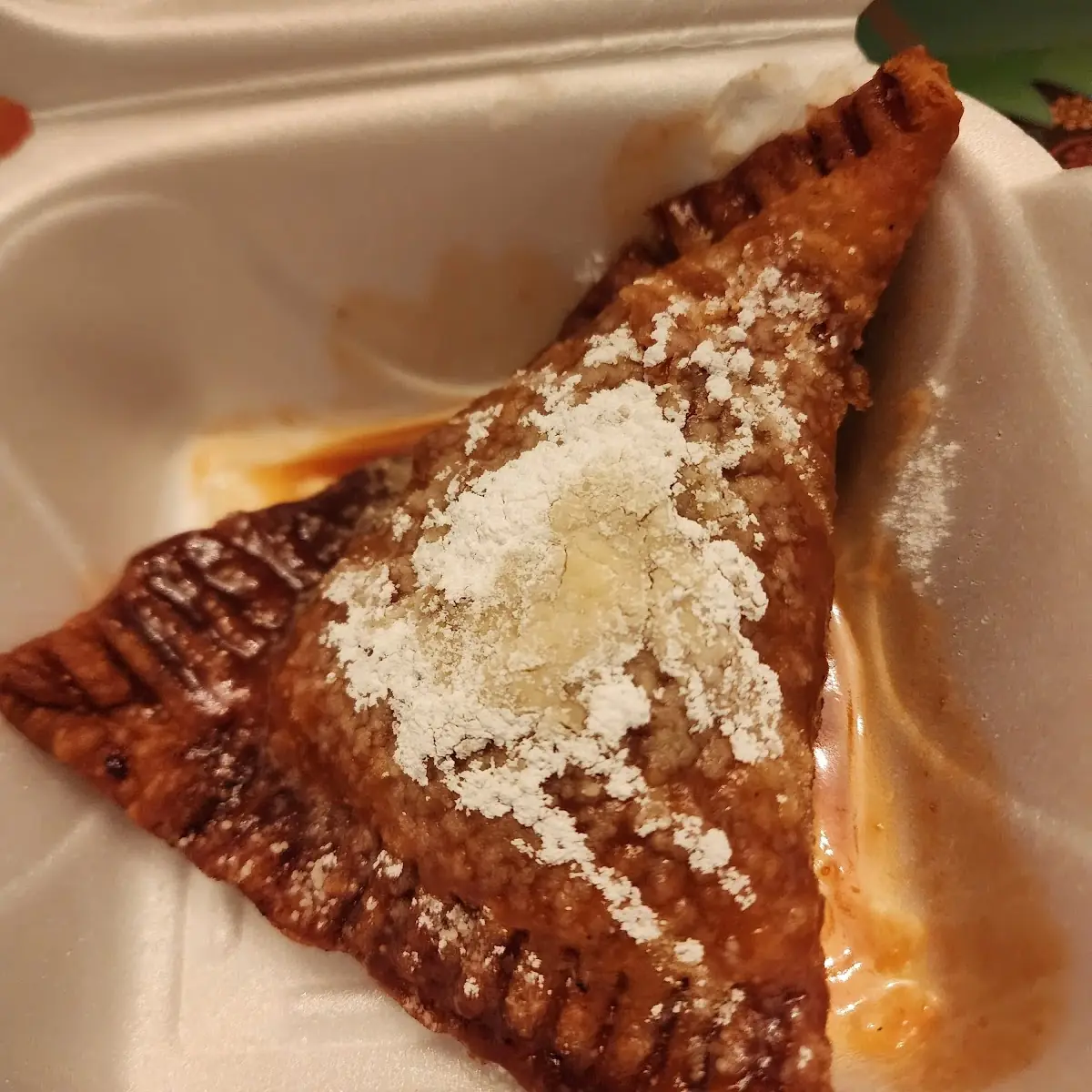 Fried Apple Pie with Caramel Sauce and Powdered Sugar