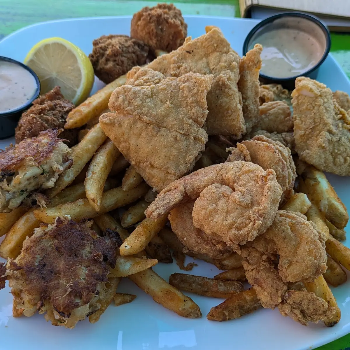 Off the Hook Fresh Fish Sandwich with Lettuce Tomato Red Onion Fried Pickles & a Side of Fries