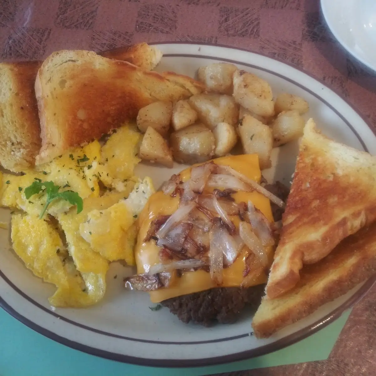 Hamburger Steak with Grilled Onions and Cheese Potatoes and Eggs with Sourdough Toast