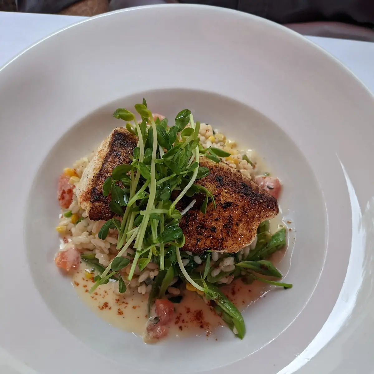 Seared Pacific Striped Bass with Leek Risotto Pea Sprouts and Kalamata Olive Beurre Blanc