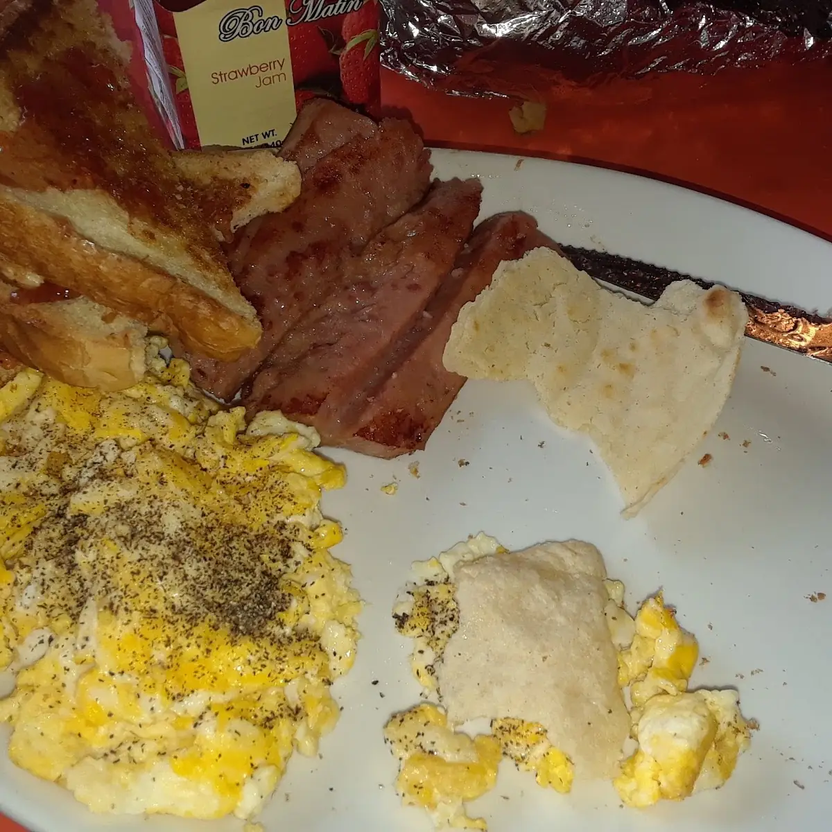 Scrambled Eggs Bacon Hash Browns and Toasted Ravioli