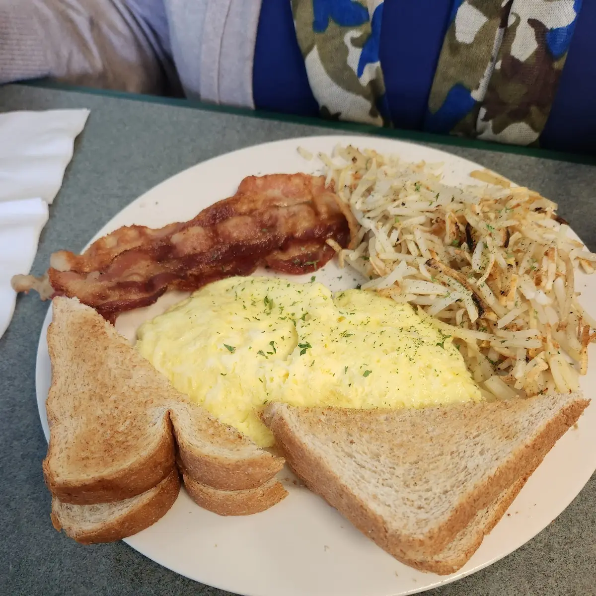 Scrambled Eggs Bacon and Toast and Hashbrowns