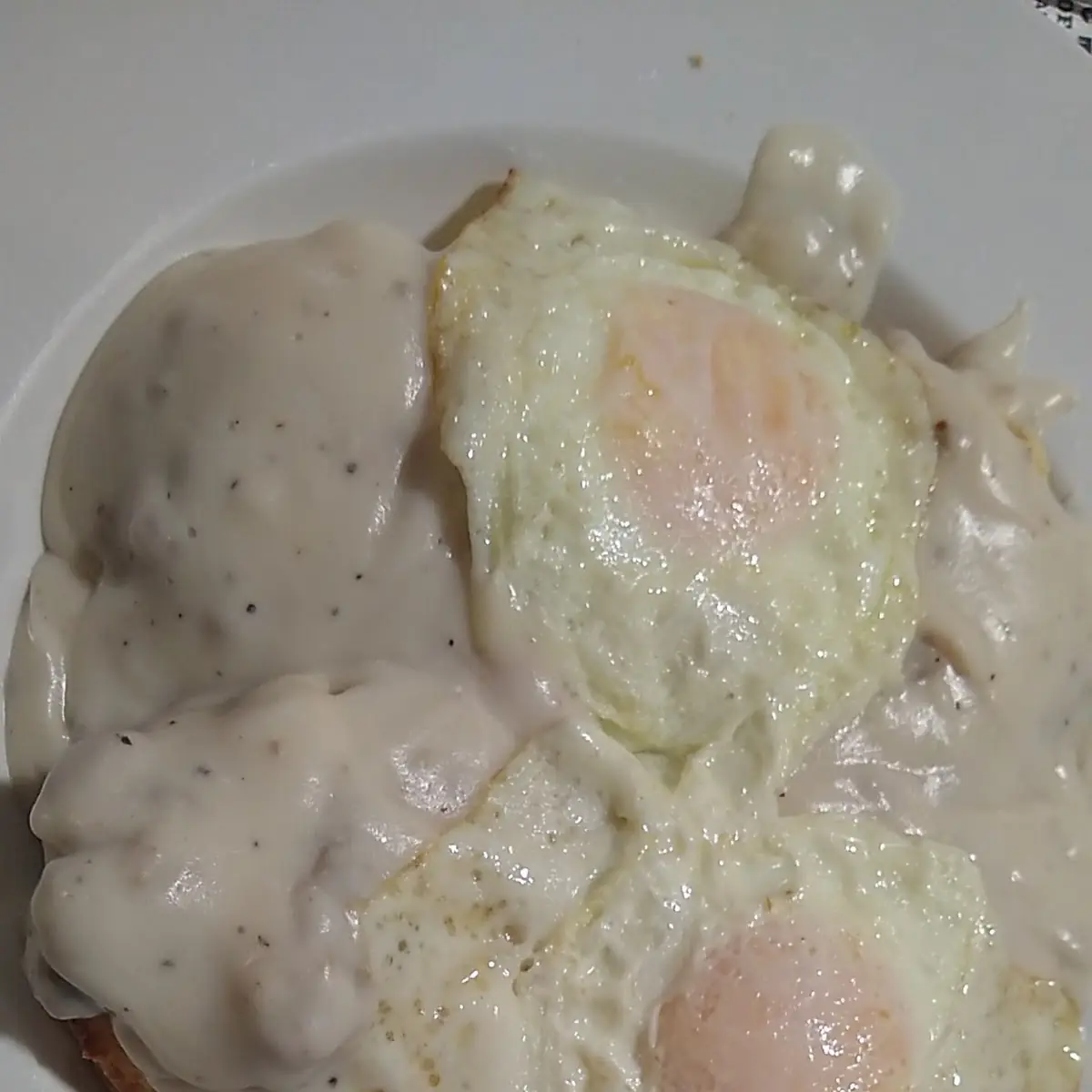 Biscuits and Gravy Topped with Two Eggs