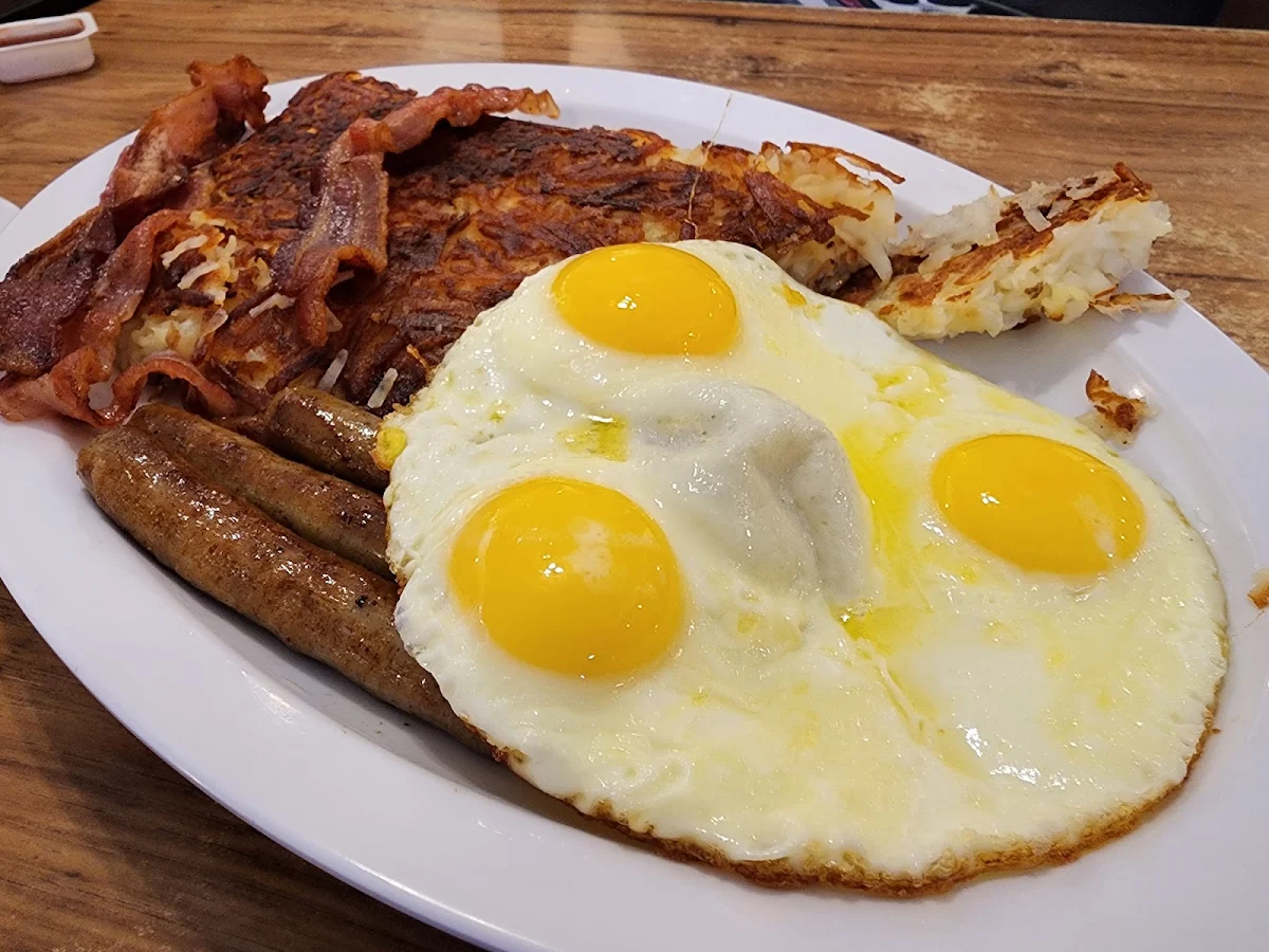 Three Eggs over Medium Sausage Hash Browns Biscuits and Gravy