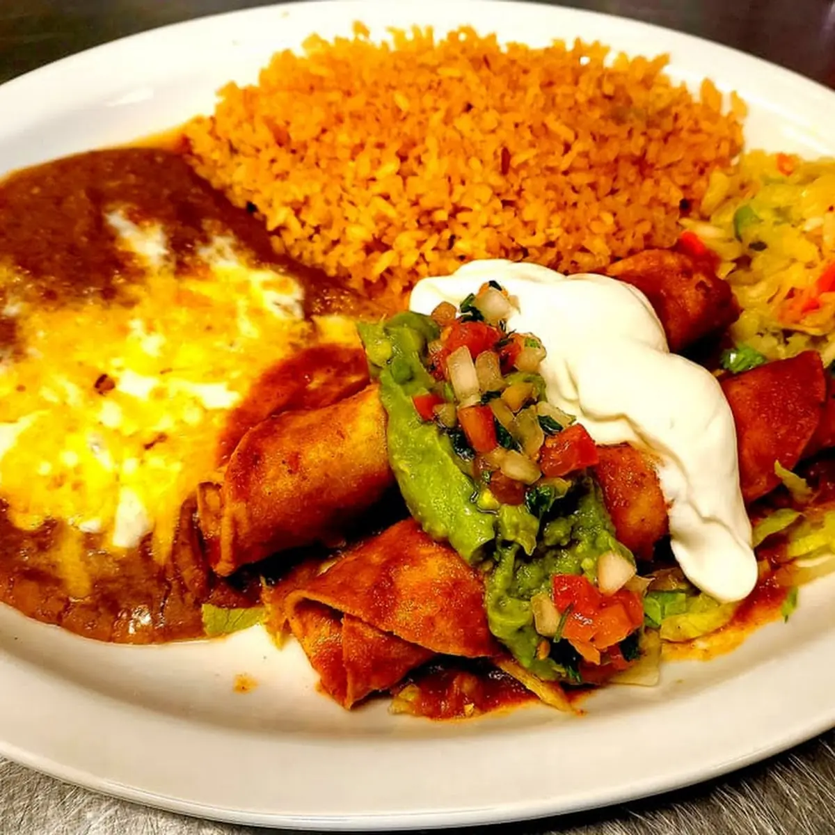 Acos and Enchilada with Red Sauce Plate Includes Rice & Beans