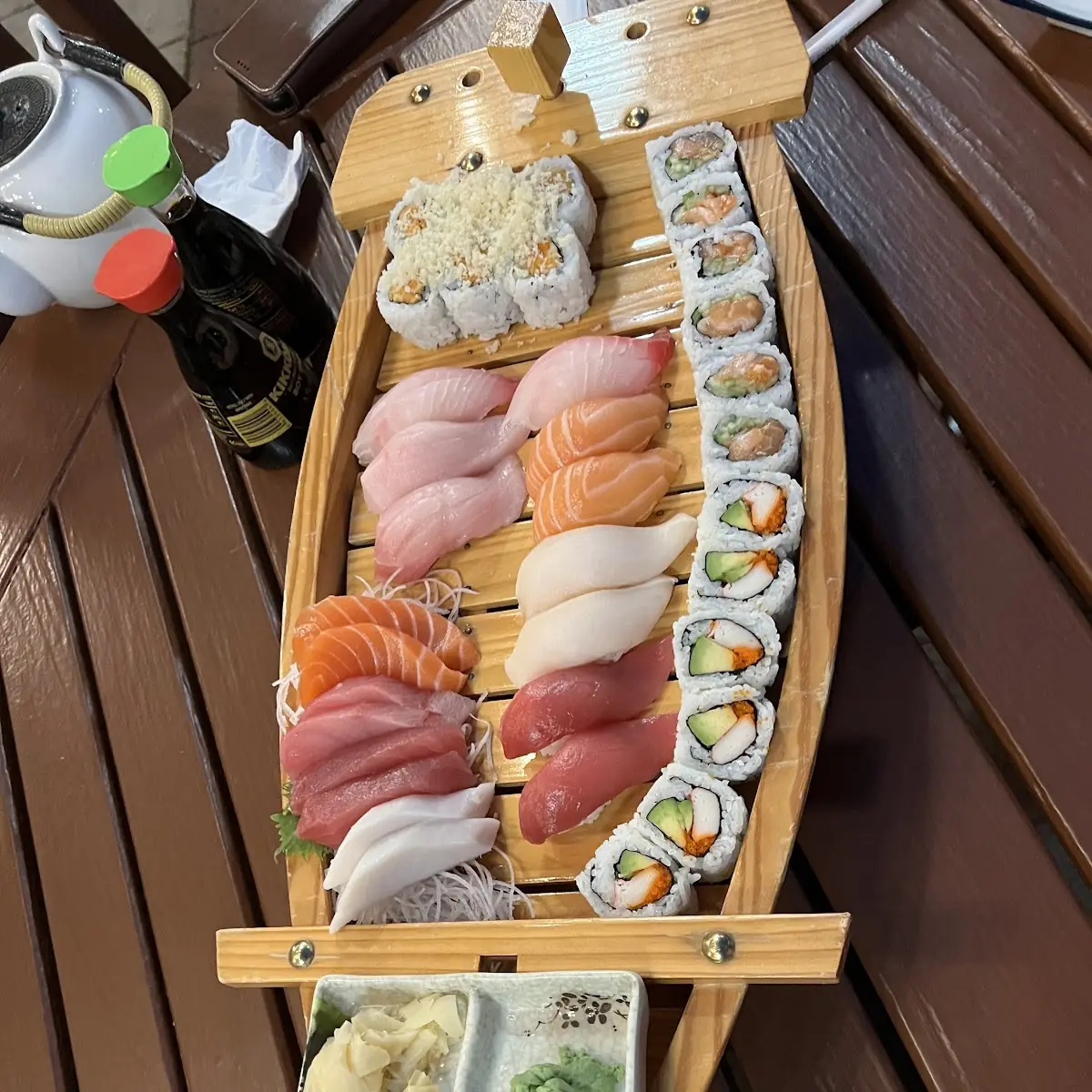 Sushi Boat with Various Rolls and Sashimi
