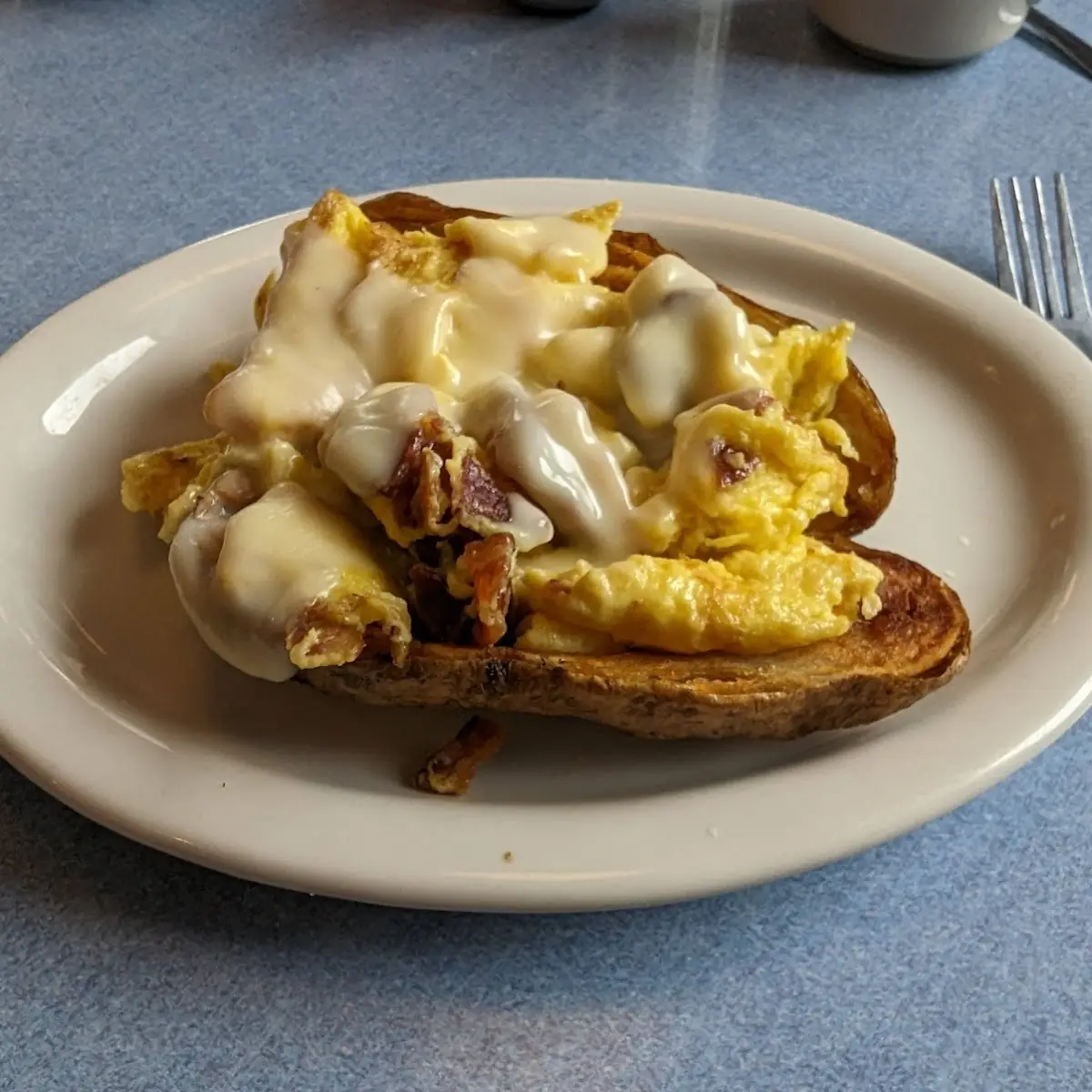 Baked Potato Loaded with Eggs Bacon and Cheese