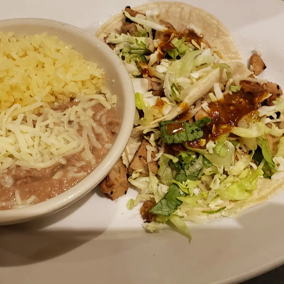 Two Chicken Tacos with Beans and Rice