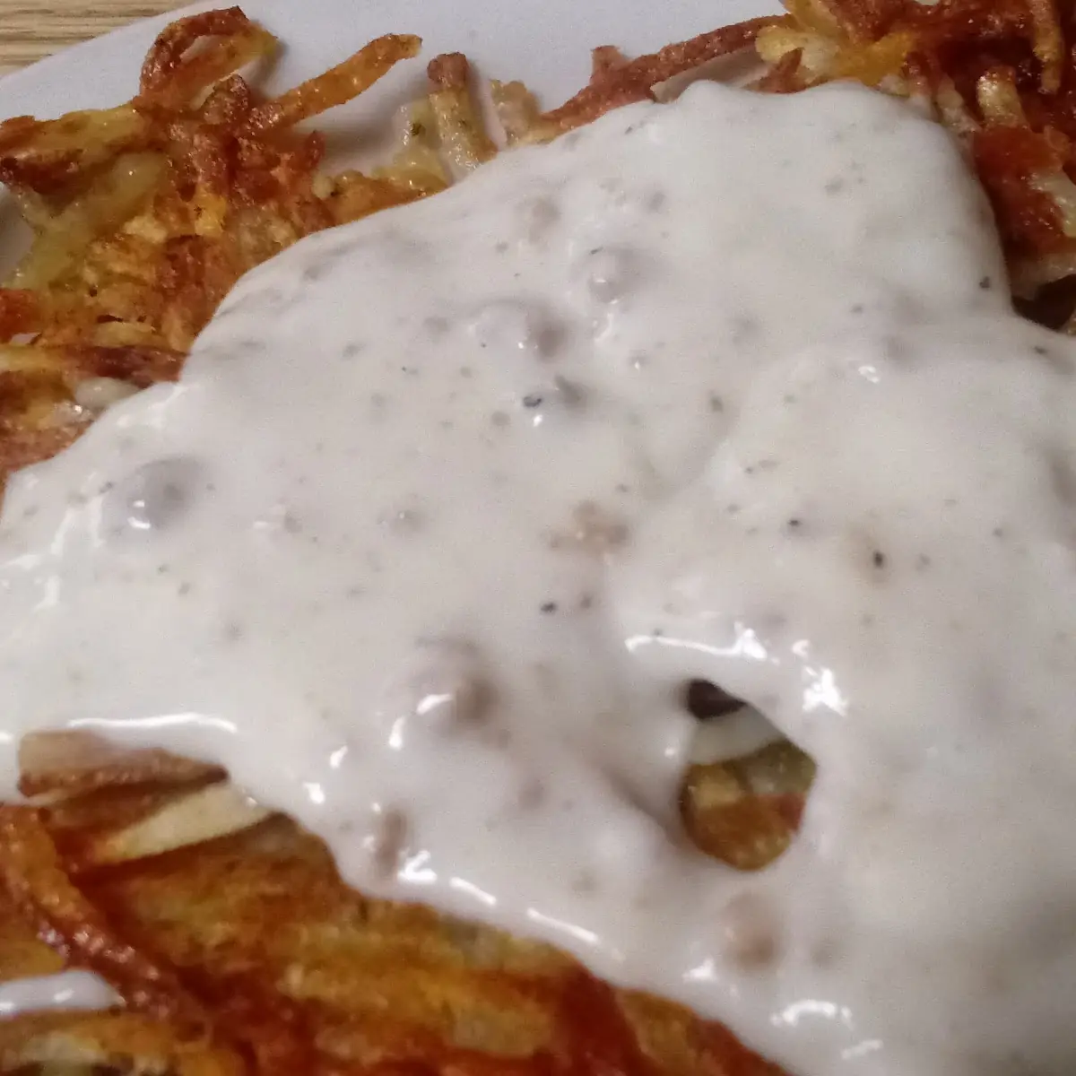 Crispy Hash Browns with Sausage Gravy on Top
