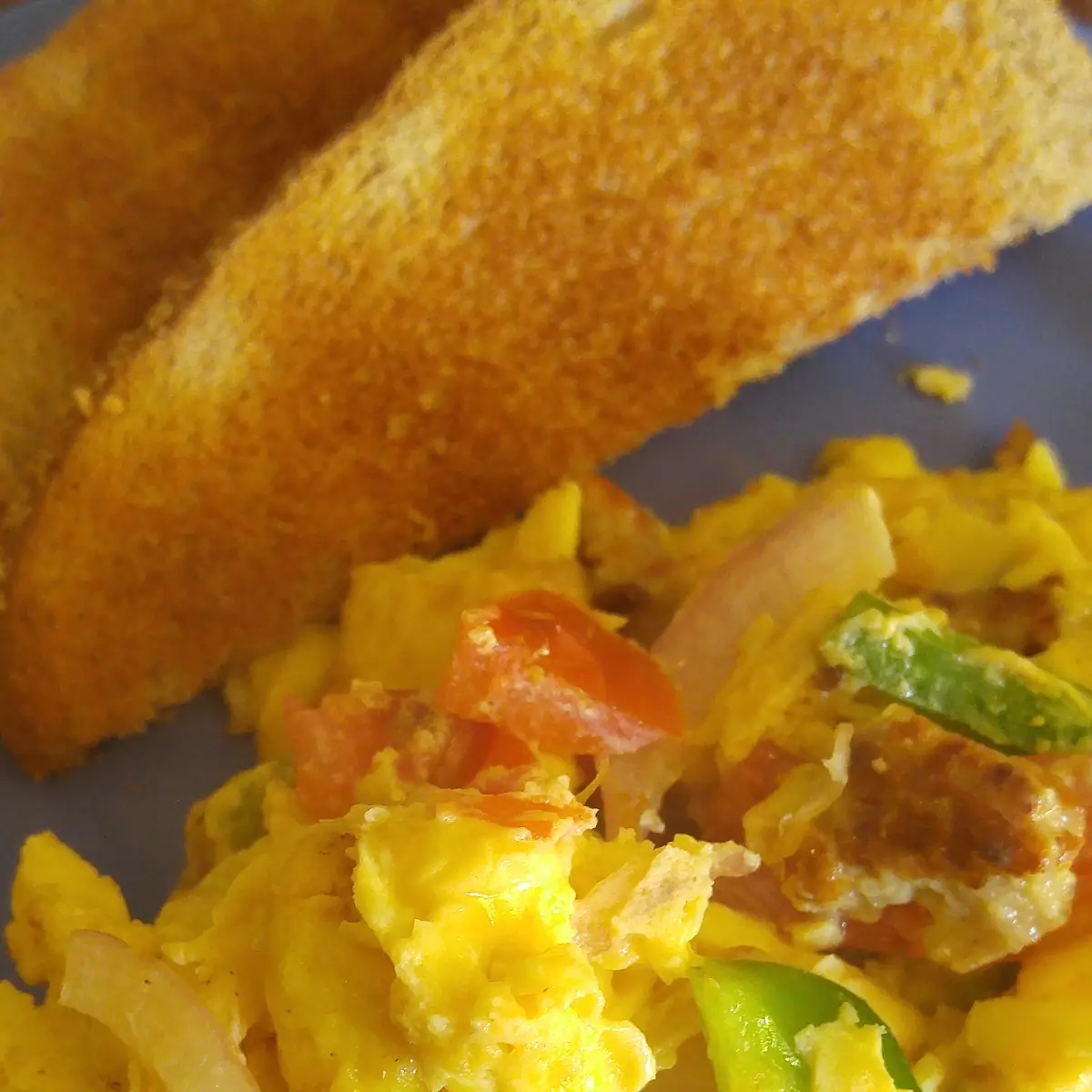 Scrambled Eggs with Bacon or Sausage Served with Toast