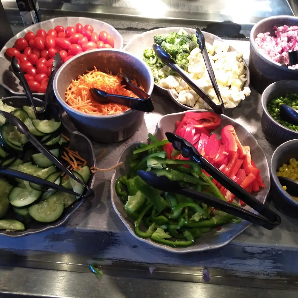 Salad Bar Onions Tomatoes Peppers Corn Peas and Cucumbers