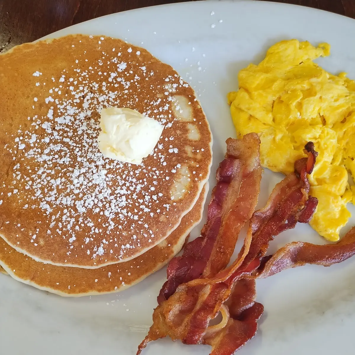 Combo Breakfast Pancakes Bacon and Scrambled Eggs