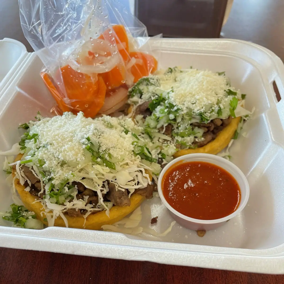 Sopes Refried Beans Asada Cabbage Onion and Cilantro and Cheese