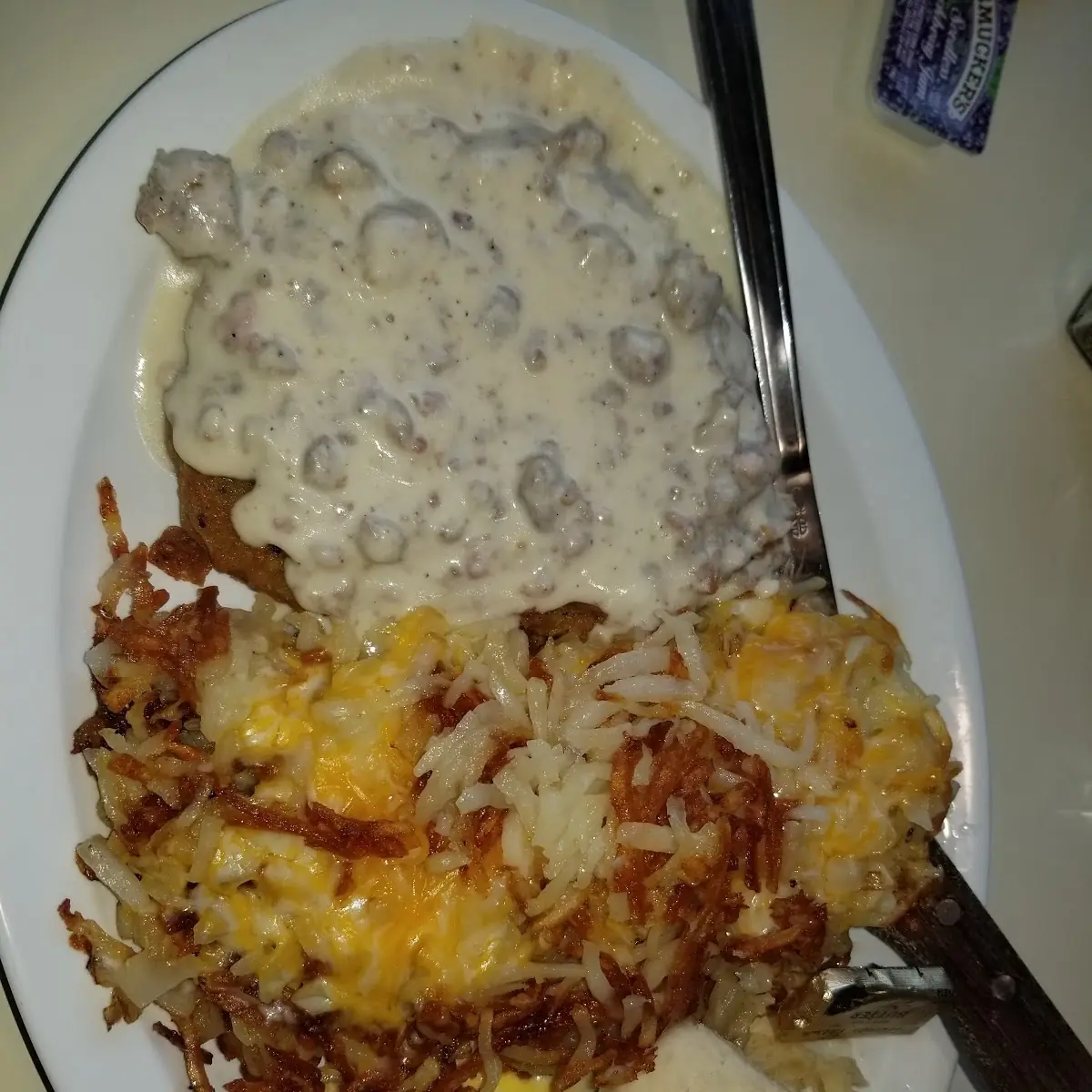 Chicken Fried Steak with Hash Browns and Eggs It Also Has Sausage Gravy on the Chicken Fried Steak