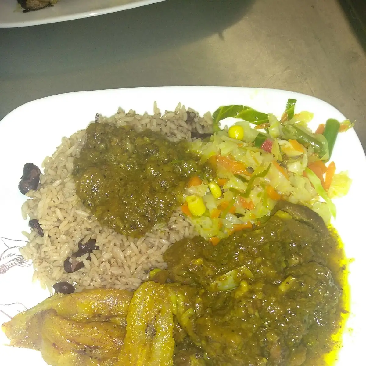 Curry Goat Steamed Veggies Rice and Peas