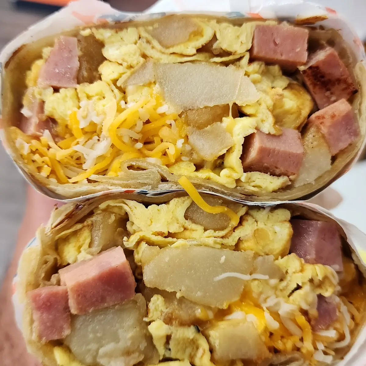 Two Eggs Potatoes Ham and Cheese Breakfast Burrito